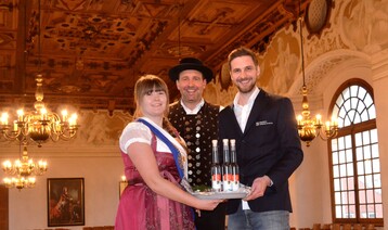 Der Dachauer Auenstellenleiter Stefan Mller, der Leiter der Schleiheimer Schlossbrennerei Alexander Bauer und die Schleiheimer Schnapsprinzessin Steffi I. (Steffi Winkler) (von rechts), mit dem neuen Dachauer Schlossbrandes vor prchtiger Kulisse im Festsaal des Dachauer Schlosses.
